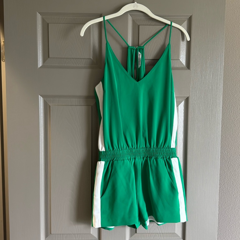 green romper with white stripes along each side. pockets.